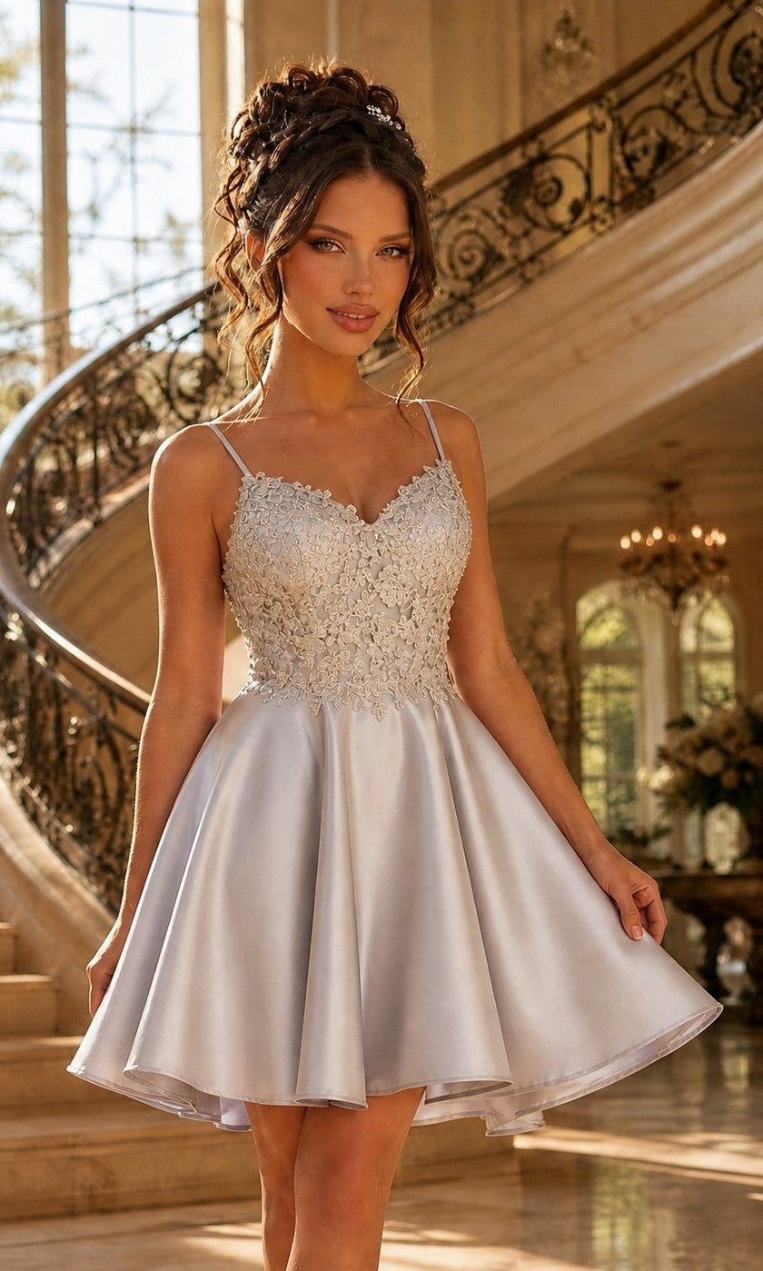 A woman in a silver Beaded-Bodice Short A-Line Homecoming Dress XR6008 stands on an elegant grand staircase.